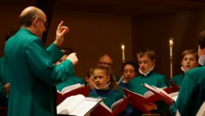 An image of All Saints' Church Lessons and Carols choir singers and musical director.